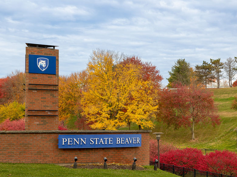 Entrance sign to Penn State Beaver with fall colors in the background