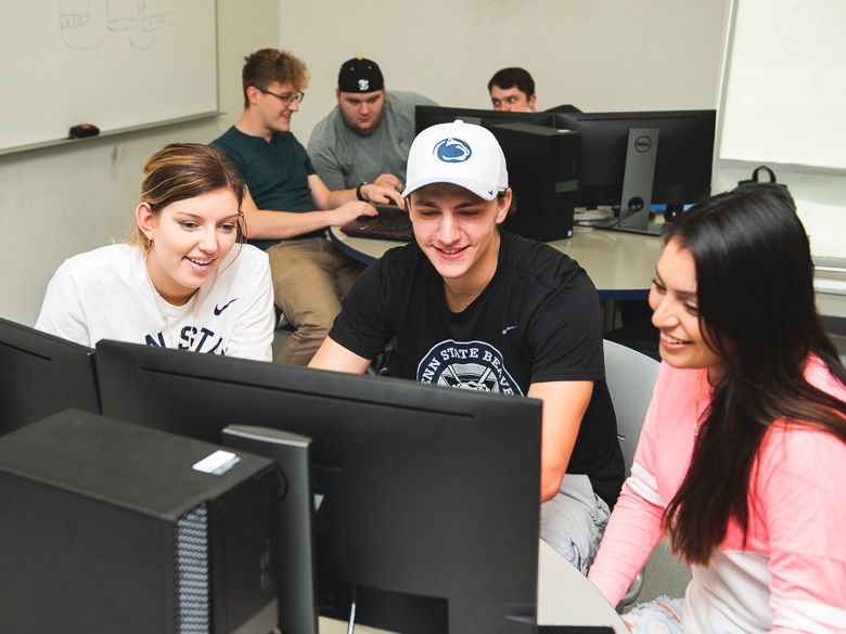 three students work together at a computer