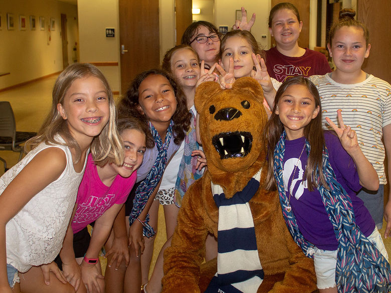 9 children pose with the Nittany Lion mascot
