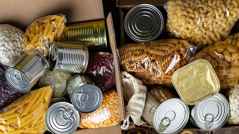 A box of pasta and canned foods