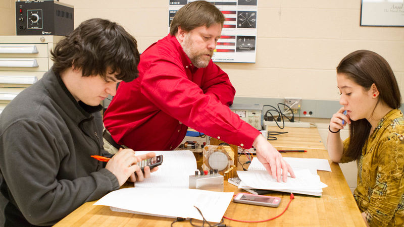Keith Willson with two students