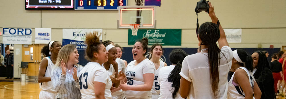 A sports photographer takes a photo of the women's basketball team after they won the 2020 USCAA National Tournament.