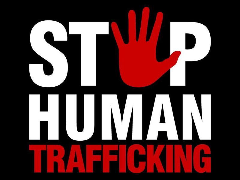 A black background with the words stop human trafficking in white and red and the image of a red handprint