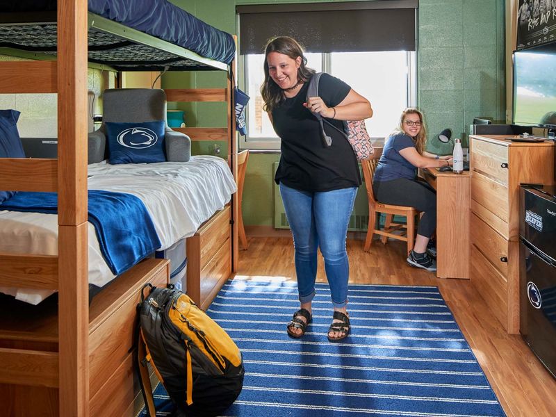 Two female students in a dorm room