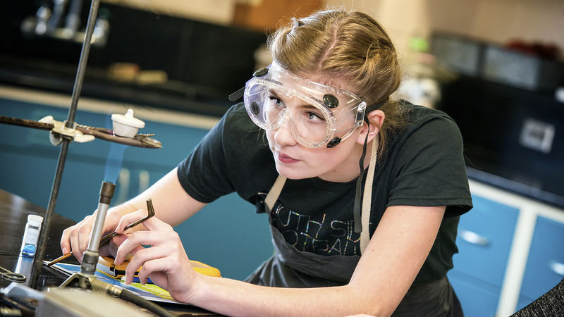 A high school student conducts a lab experiment as part of the Beaver Science Challenge.
