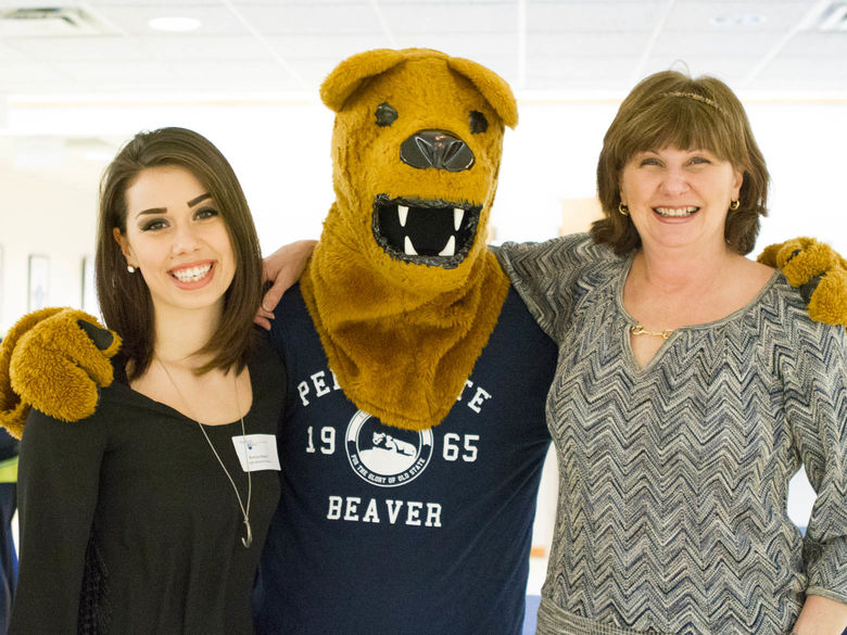 A student and her mother pose with the Nittany Lion at an accepted student event