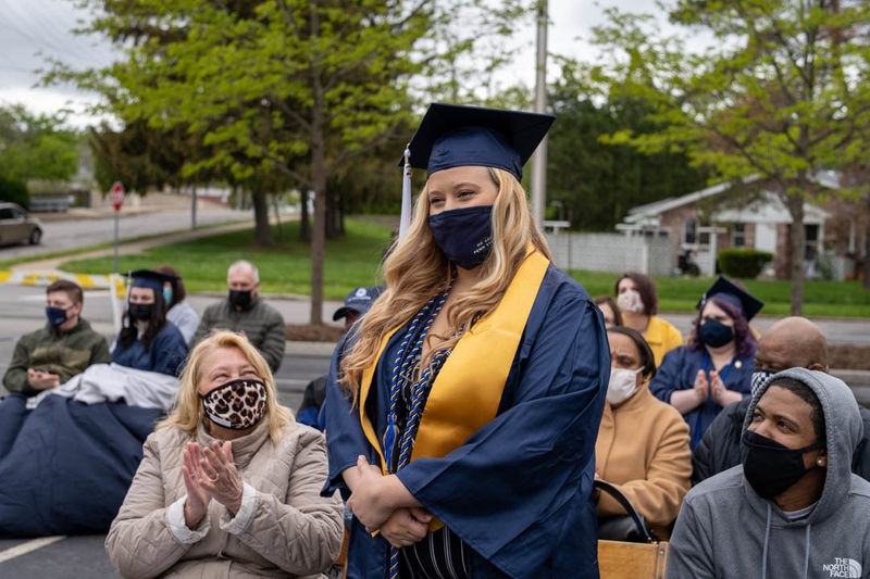 Erika Detwiler standing while audience around her claps. 