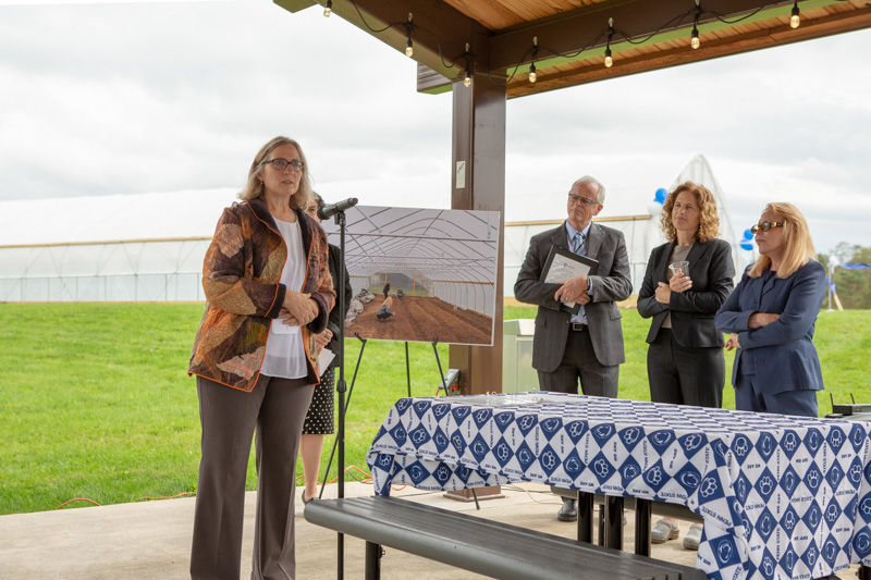 Angela Fishman speaks in front of the high tower