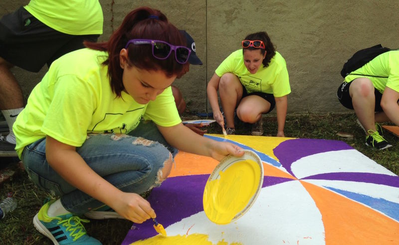 Penn State Beaver freshman Nicole Pastorino paints a wooden pallet.