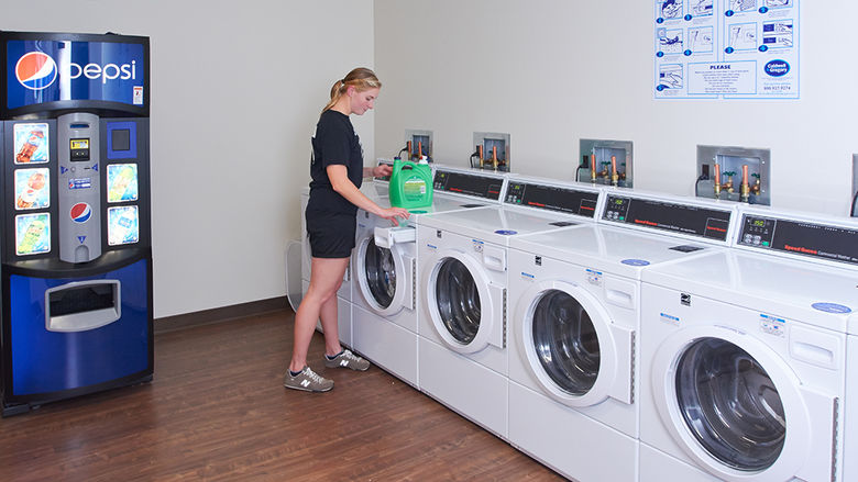 Student in on-campus laundry facility