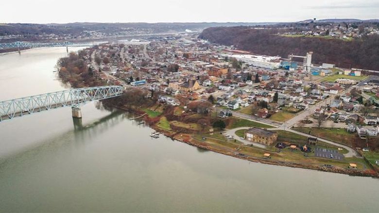 An aerial view of Beaver County with a river bending in the left of the photograph, a bridge, and a town to the right