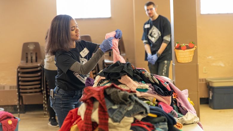 Student sorting clothes at the Salvation Army