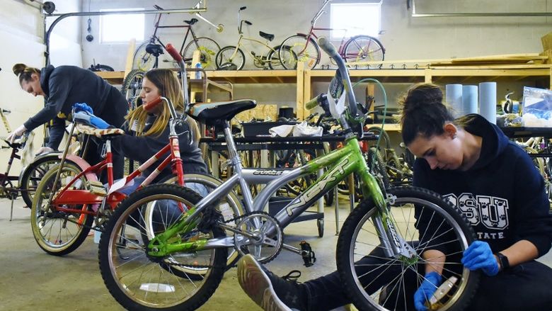 Penn State students repair bicycles during a Martin Luther King Jr. Day service project.