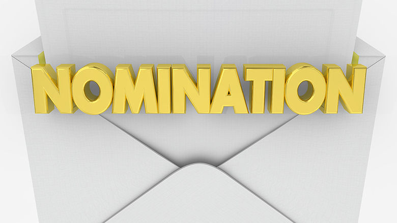 A picture of a white envelope opening with the word nomination in yellow letters