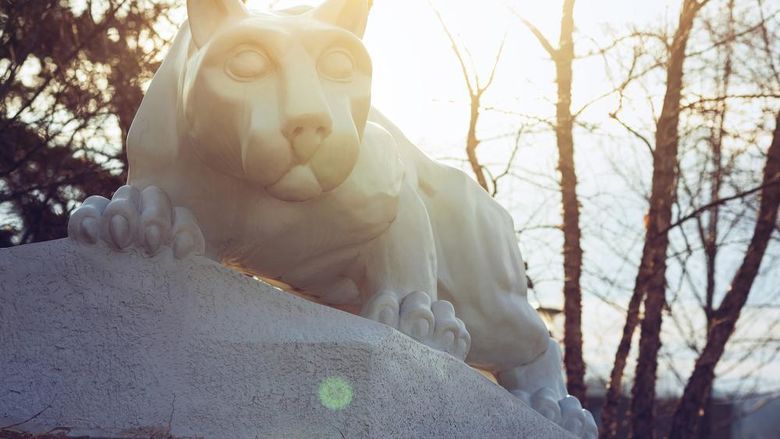 A photo of the lion shrine in late fall with sunlight behind it