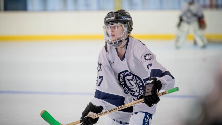 Forward Peri Coleman holding her stick in the rink.