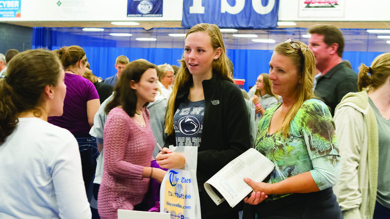 Students and parents attend the college fair
