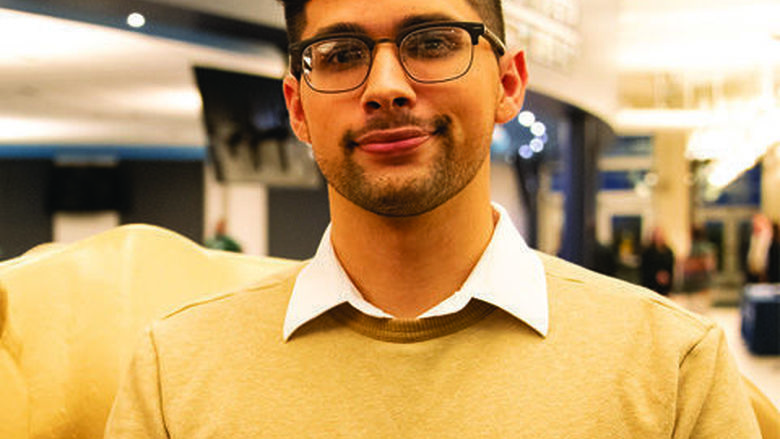 Joshua Simon posing in front of a Nittany Lion sculpture