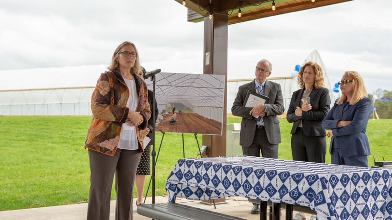 Angela Fishman speaks in front of the high tower