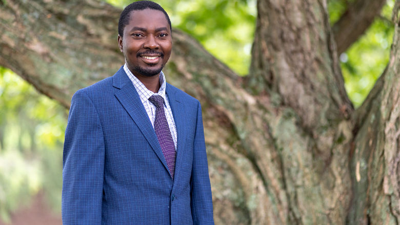 A person wearing a shirt, tie and blue suit jacket. 