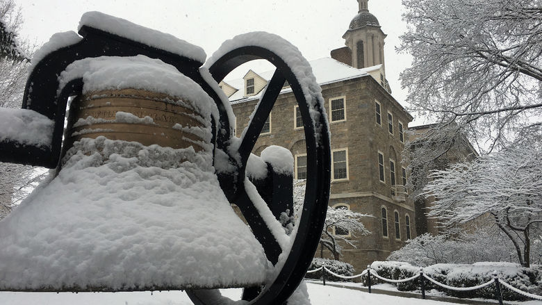 Snow falls on Old Main bell