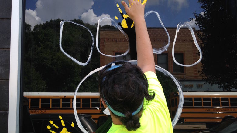 Sophomore Nick Pelino paints a handprint on a window.