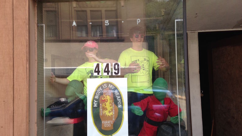 Penn State students pose in a business window.