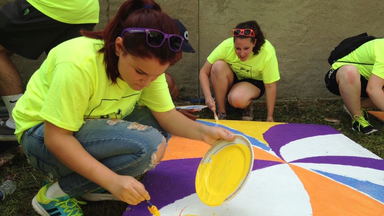 Penn State Beaver freshman Nicole Pastorino paints a wooden pallet.