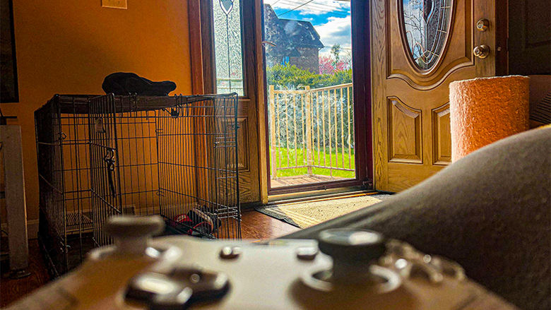 video game controller pointing toward open door