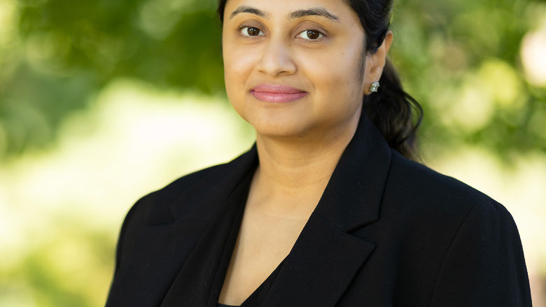 A photo of Dr. Ray wearing a black jacket and standing outside