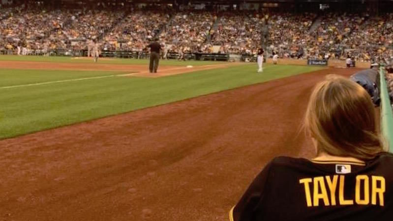 Taylor Myers watches baseball game from field level.