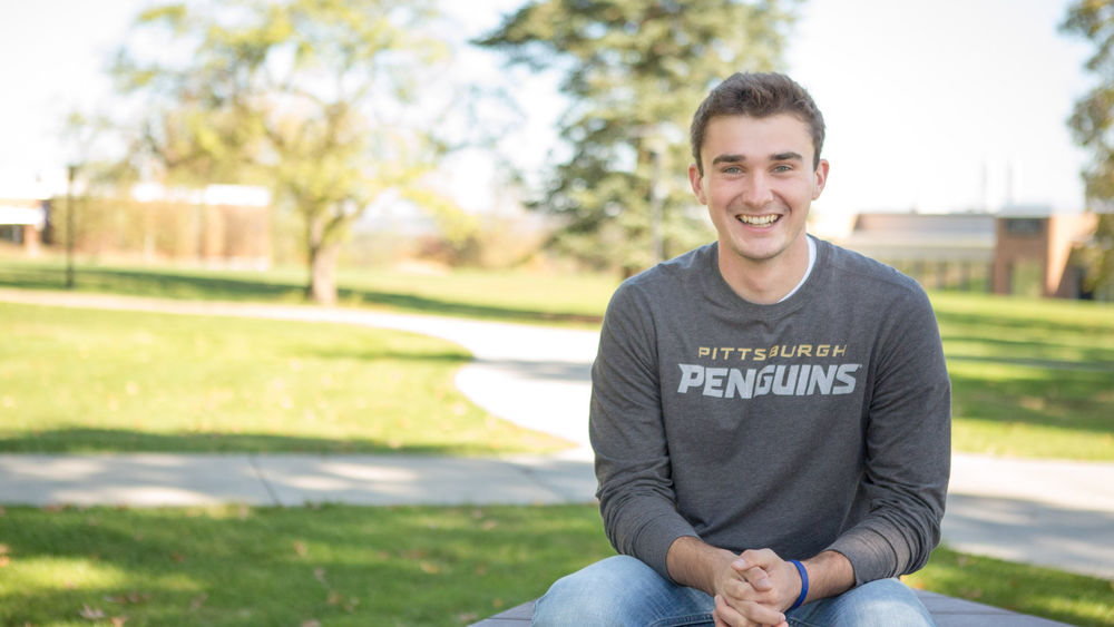 Beaver student Ty Cole sits at picnic table on campus.