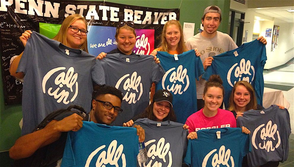 Eight Beaver students pose with their "All In" T-shirts in the Brodhead Bistro.