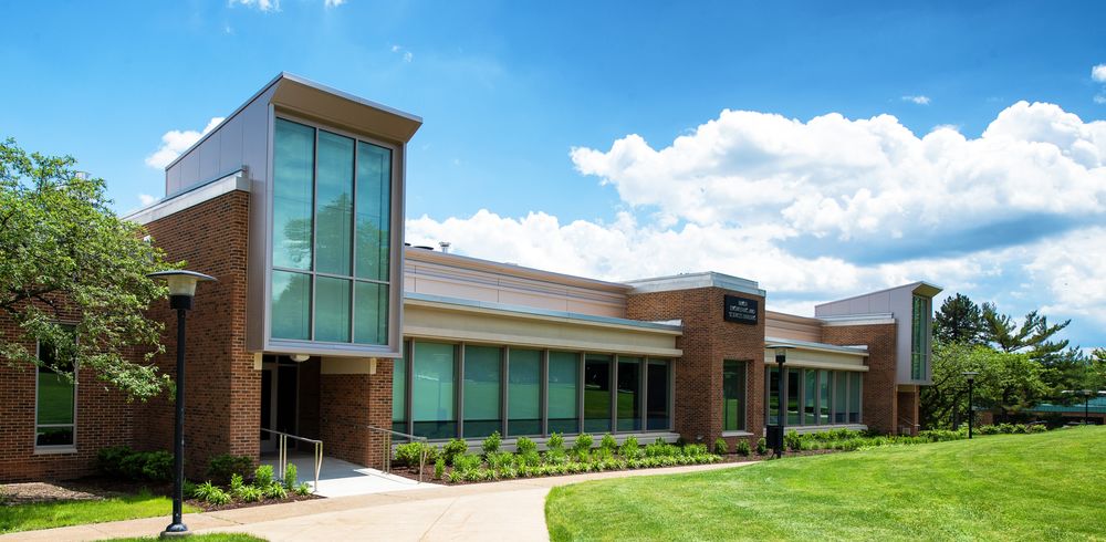 The brick-and-glass Michael Baker Building on a summer day.