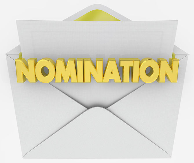 A picture of a white envelope opening with the word nomination in yellow letters