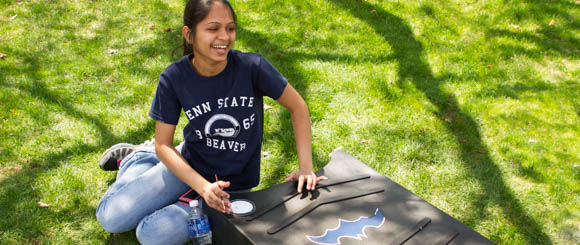 Ruhi Patel paints a bat house for the Beaver campus.