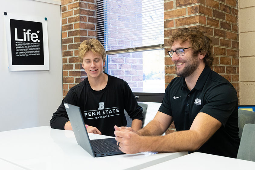 Frankie meets with a student in the library