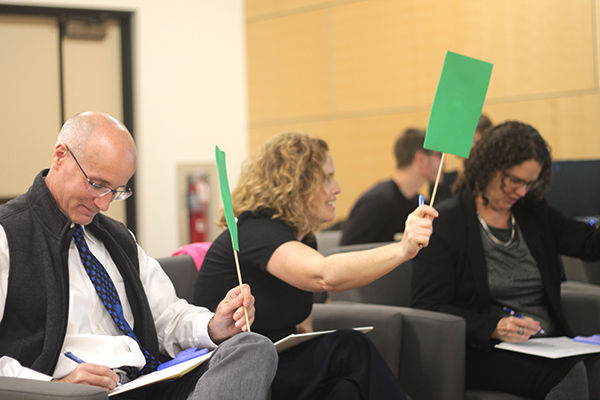 Judges hold up cards at the campus Lion's Den competition
