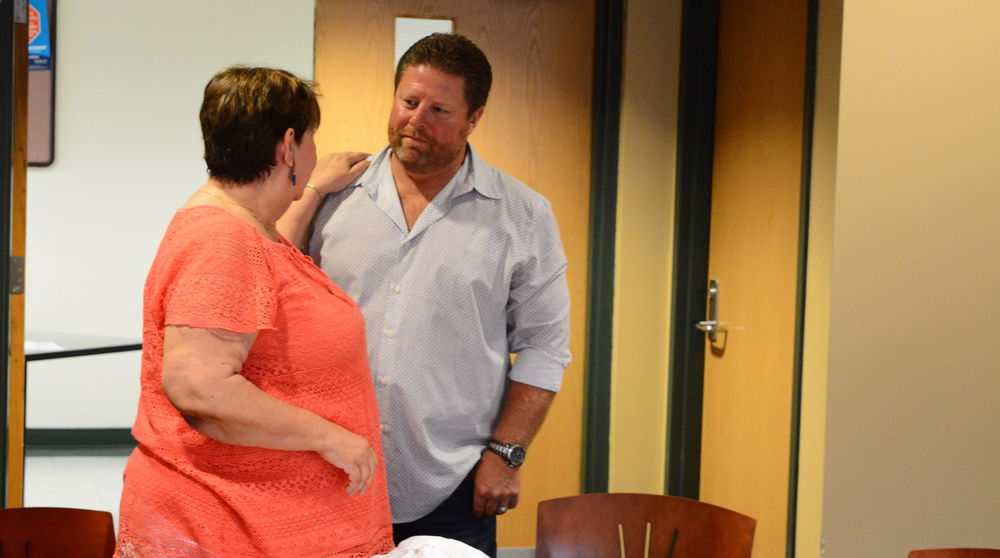 Matt Morgan speaks with a community member after his speech.