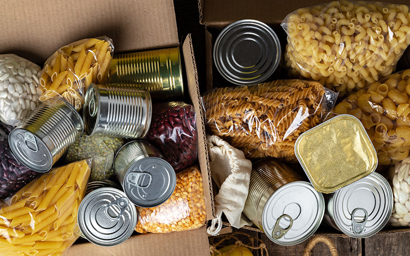 A box of pasta and canned foods